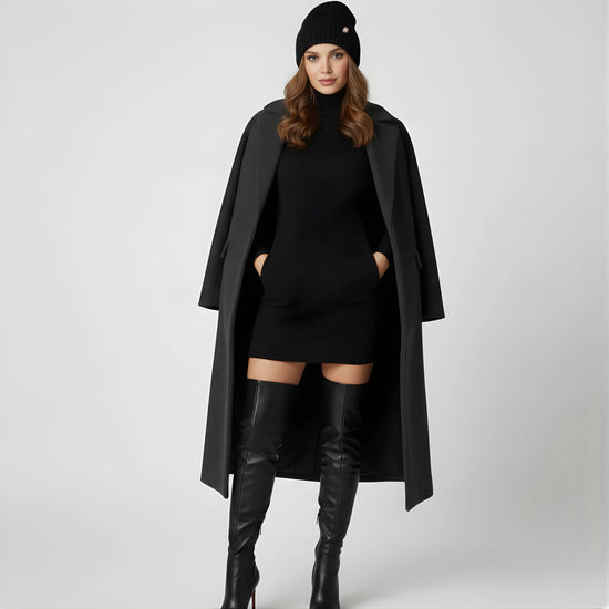 Woman in black trench coat with black turtleneck dress and boots